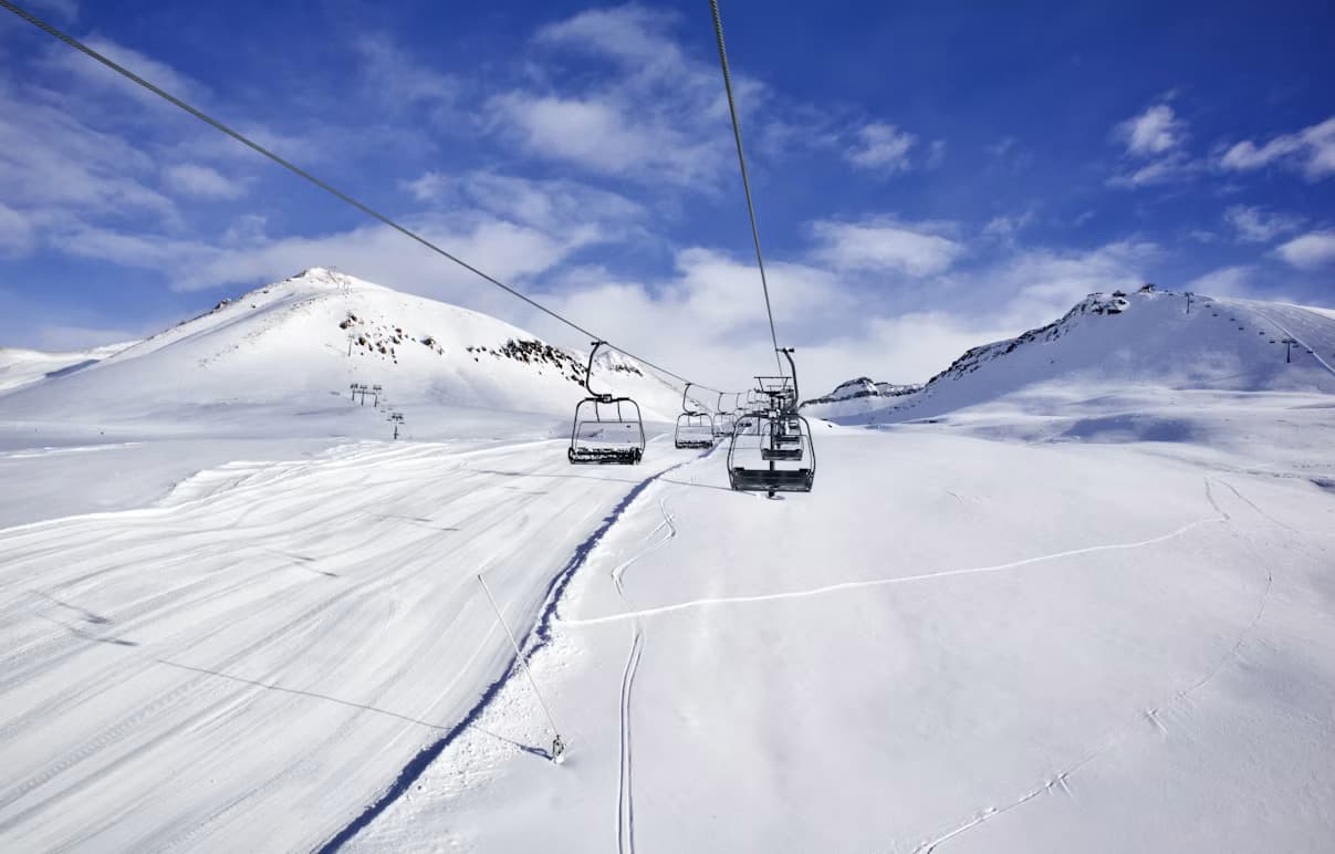Gudauri chairlift, empty piste and mountain peaks